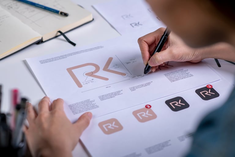 Designer sketching logo concepts on paper