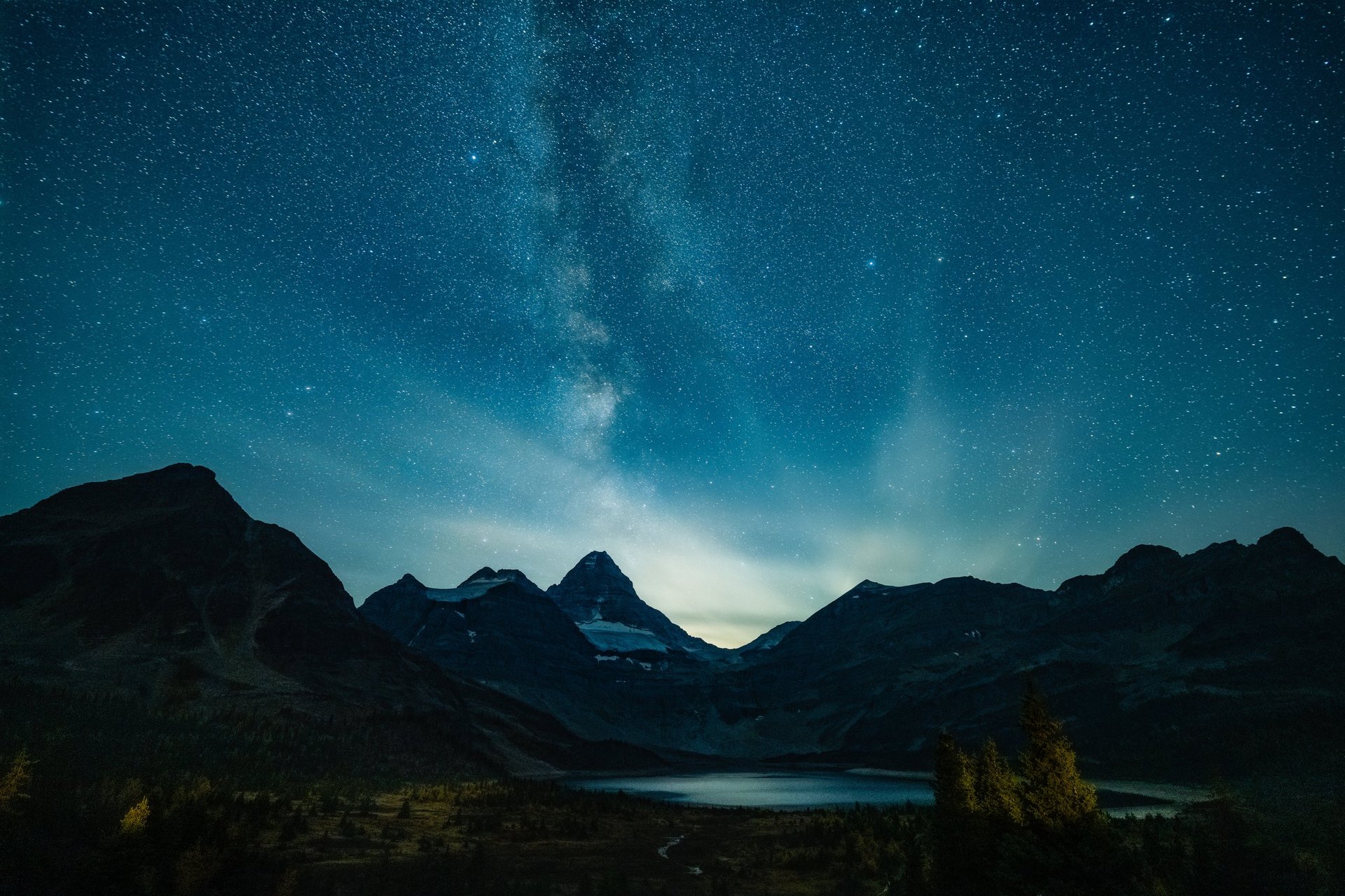 Milky Way arches over Mount Assiniboine, illuminating rugged alpine peaks